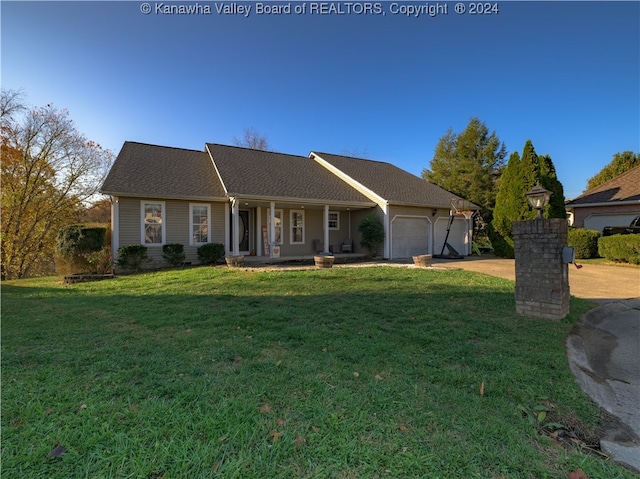 ranch-style house featuring a front lawn, a garage, and a porch