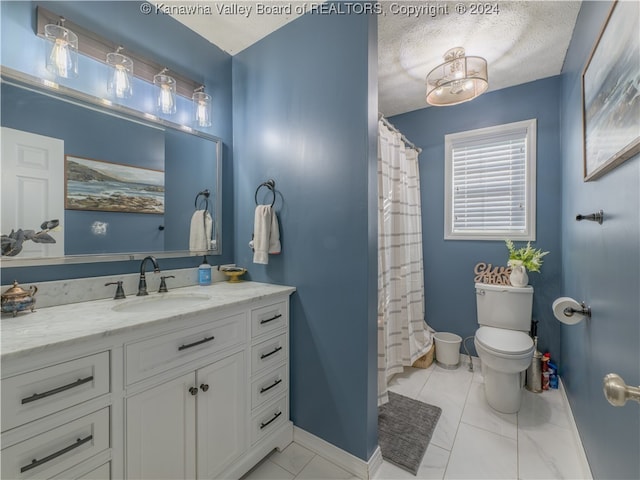 bathroom featuring toilet, vanity, a textured ceiling, and tile patterned flooring