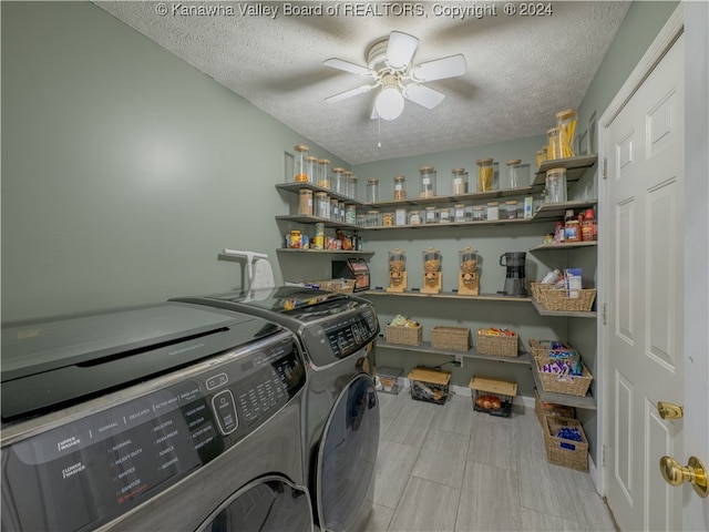 laundry area with washing machine and clothes dryer, ceiling fan, and a textured ceiling