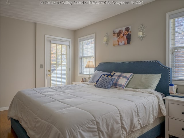 bedroom with hardwood / wood-style floors and a textured ceiling