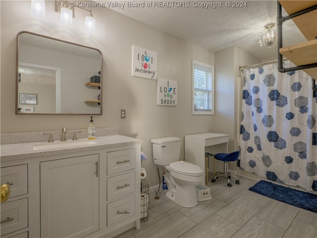 bathroom featuring vanity, a textured ceiling, curtained shower, toilet, and a chandelier