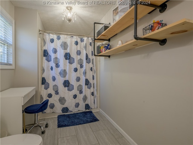 bathroom featuring a textured ceiling and a shower with shower curtain