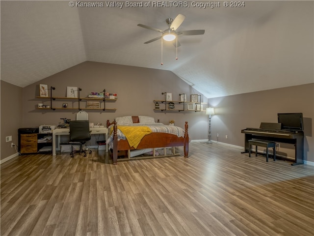 bedroom with hardwood / wood-style floors, vaulted ceiling, and ceiling fan