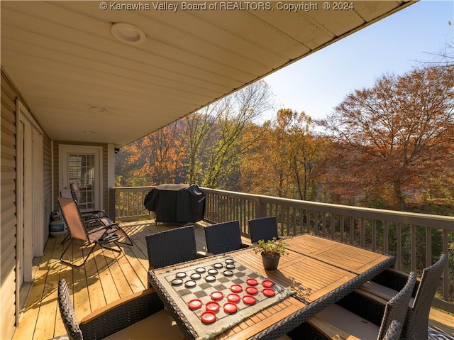 wooden terrace featuring a grill