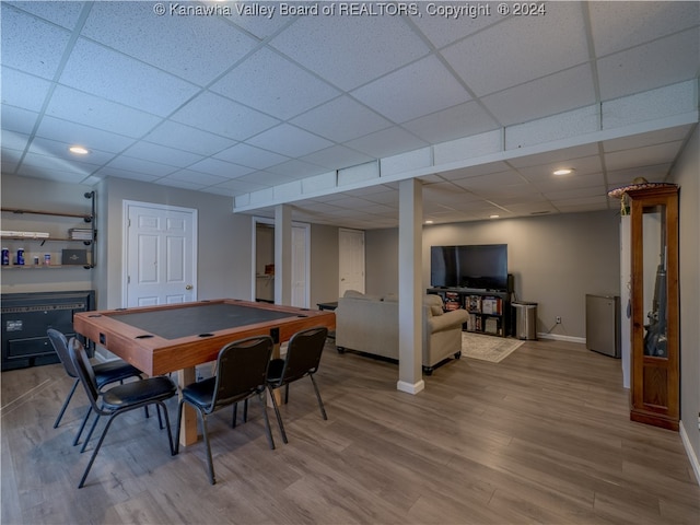 dining area featuring a paneled ceiling and wood-type flooring