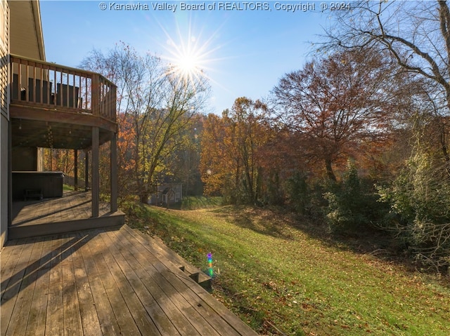 wooden terrace featuring a lawn