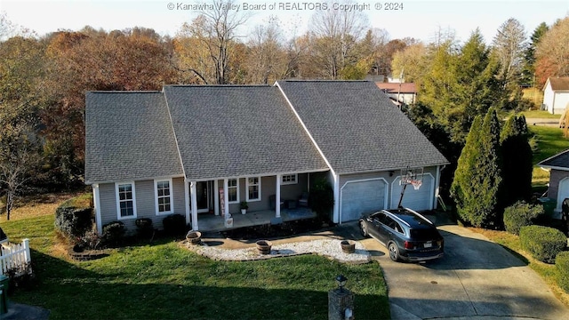 cape cod house featuring a garage and a front yard