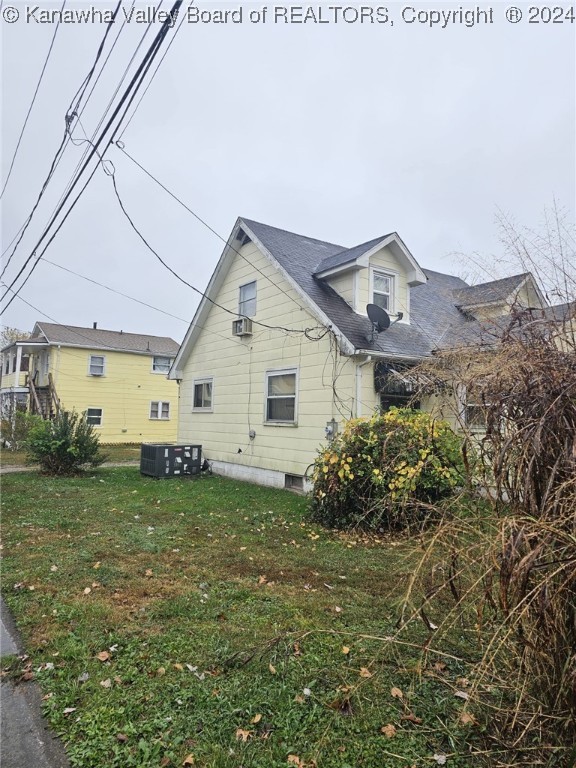 view of side of home with a lawn