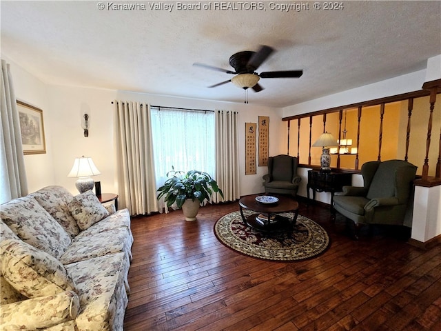 living room featuring dark hardwood / wood-style flooring, a textured ceiling, and ceiling fan