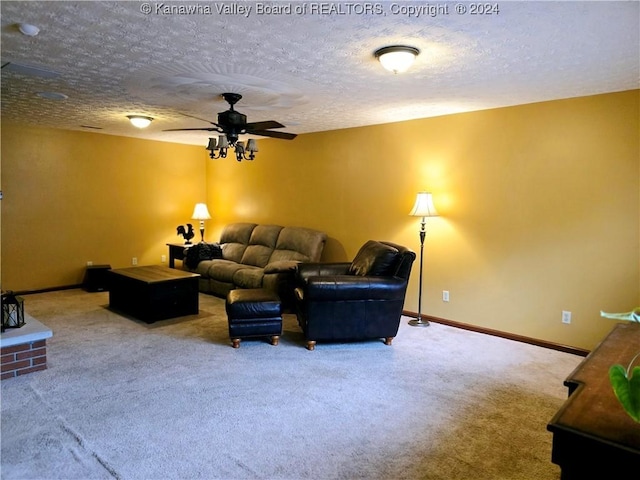 carpeted living room featuring ceiling fan and a textured ceiling