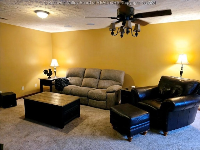 carpeted living room with ceiling fan and a textured ceiling