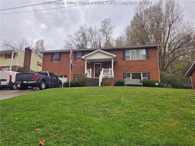 split foyer home featuring a front yard and covered porch