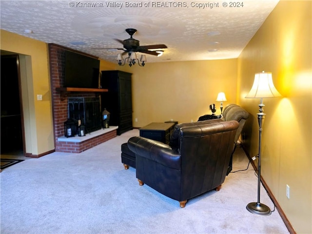 living room featuring light carpet, a brick fireplace, a textured ceiling, and ceiling fan