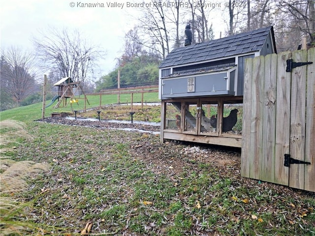 view of yard featuring an outbuilding and a playground