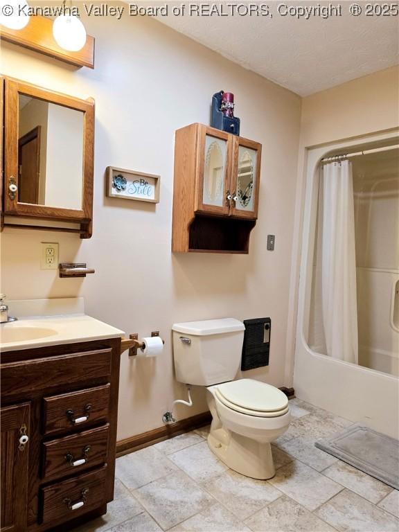 full bathroom with vanity, shower / bath combo with shower curtain, and toilet