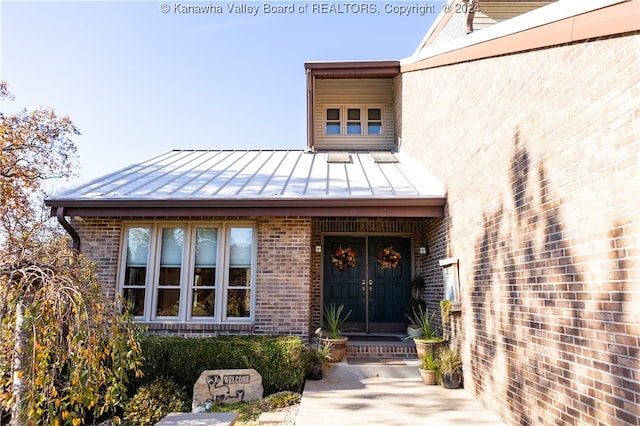 view of exterior entry with covered porch