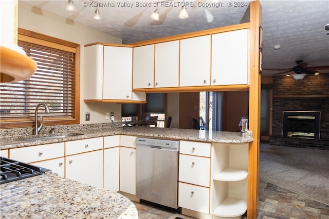 kitchen with dishwasher, a textured ceiling, and white cabinetry