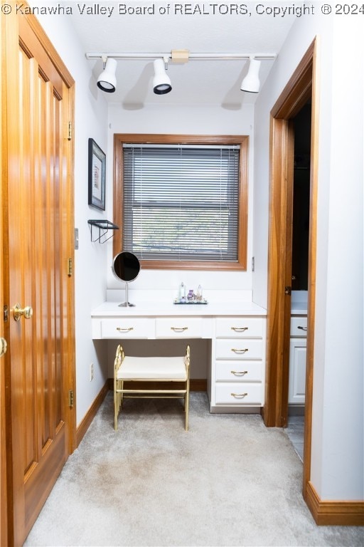 office area featuring light carpet and built in desk