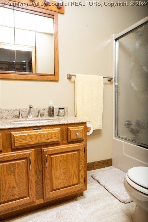 full bathroom with vanity, toilet, and bath / shower combo with glass door