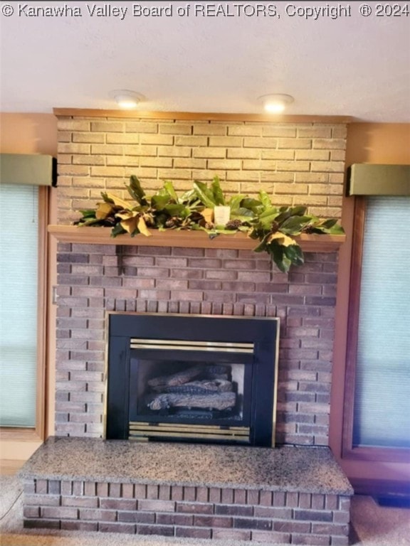 details featuring carpet flooring and a brick fireplace