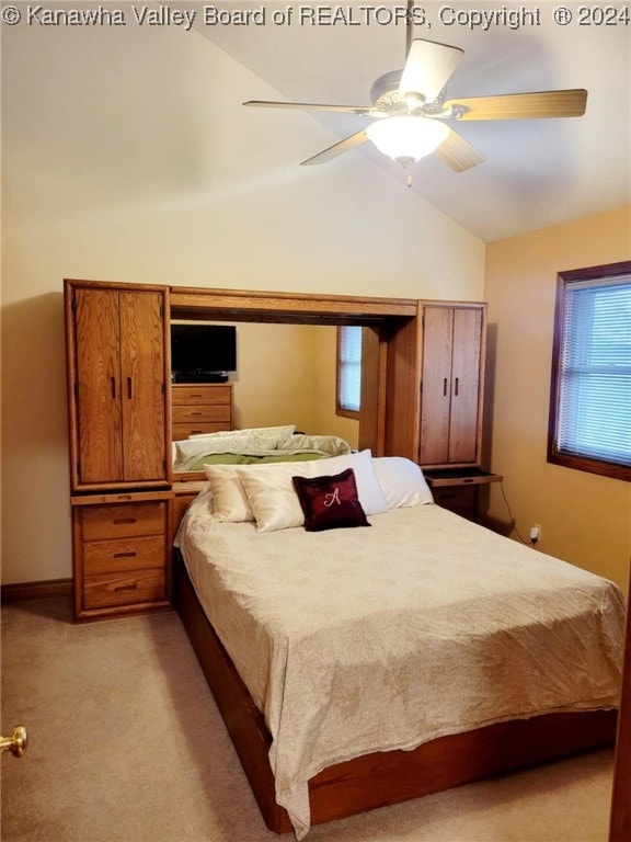 bedroom featuring ceiling fan, light colored carpet, and lofted ceiling