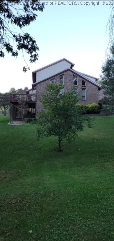 exterior space featuring a yard and a wooden deck