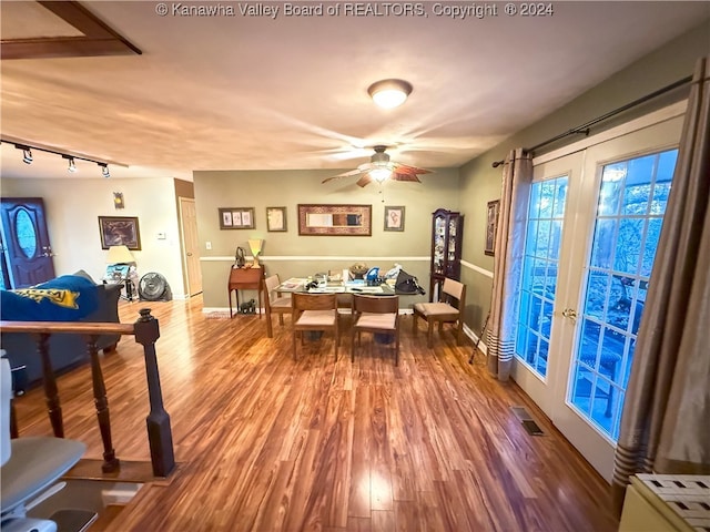 recreation room featuring rail lighting, hardwood / wood-style floors, ceiling fan, and french doors