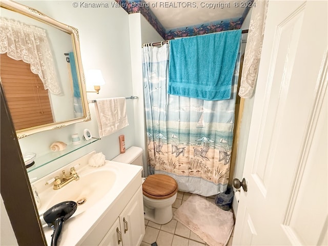 bathroom featuring toilet, vanity, tile patterned flooring, and curtained shower