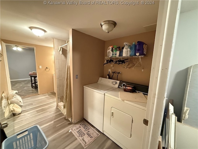 washroom featuring light wood-type flooring and washer and clothes dryer