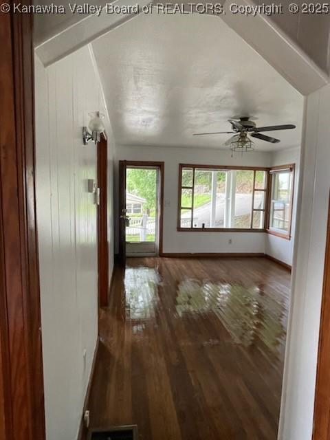 interior space with dark hardwood / wood-style floors and ceiling fan