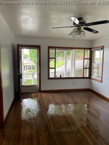 interior space with dark hardwood / wood-style floors and ceiling fan