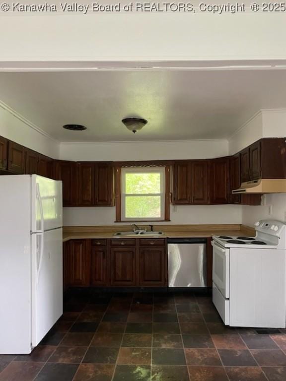 kitchen with dark brown cabinetry, sink, and white appliances