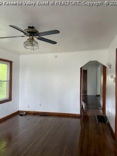 spare room featuring ceiling fan and dark hardwood / wood-style flooring