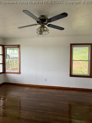 empty room featuring hardwood / wood-style floors, ceiling fan, and a wealth of natural light