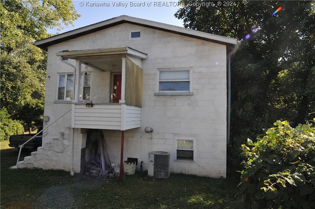 back of house with central air condition unit