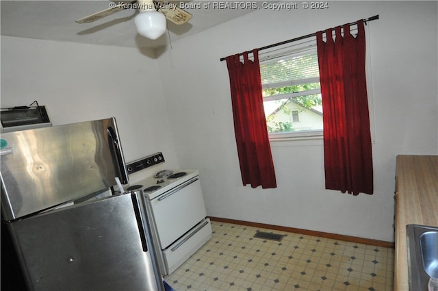 kitchen featuring ceiling fan, stainless steel fridge, and white electric stove