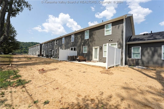 rear view of property featuring central air condition unit