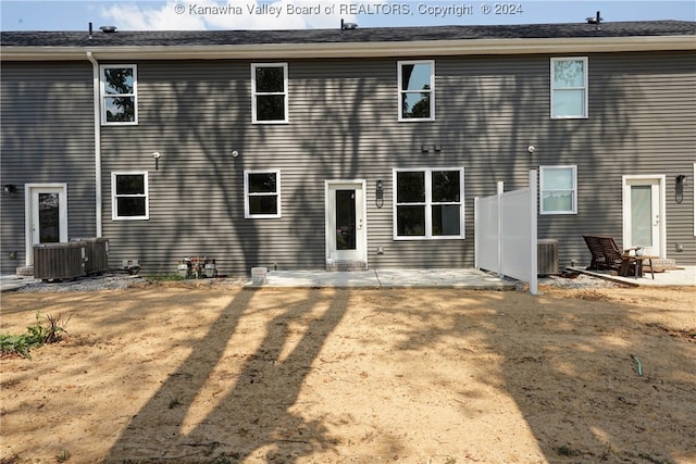 back of house with cooling unit and a patio