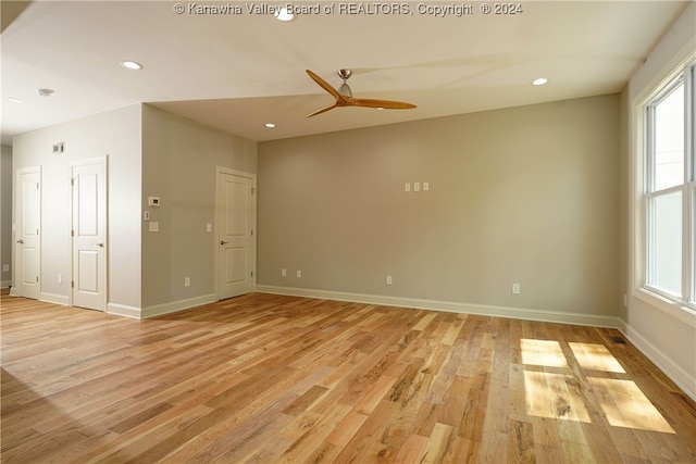 unfurnished room with ceiling fan and light hardwood / wood-style flooring