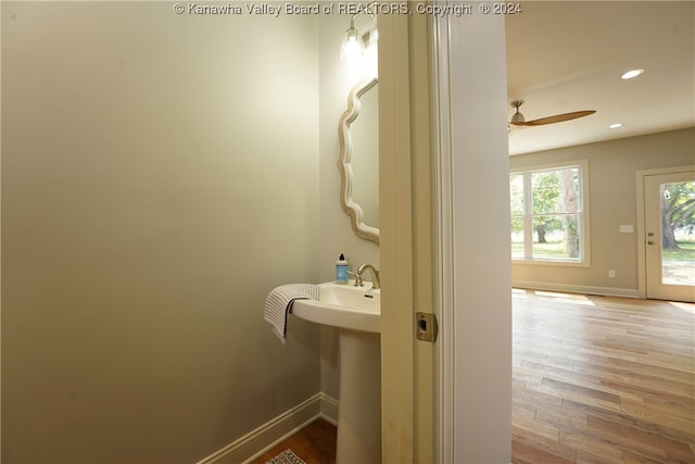 bathroom with hardwood / wood-style floors and ceiling fan