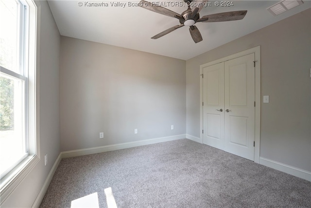 unfurnished bedroom featuring a closet, ceiling fan, and carpet floors