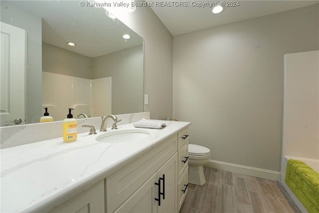 bathroom featuring wood-type flooring, vanity, and toilet