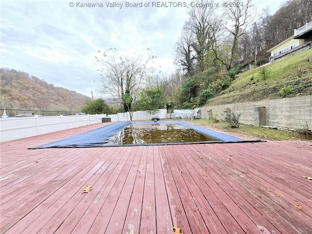 view of pool featuring a deck with mountain view