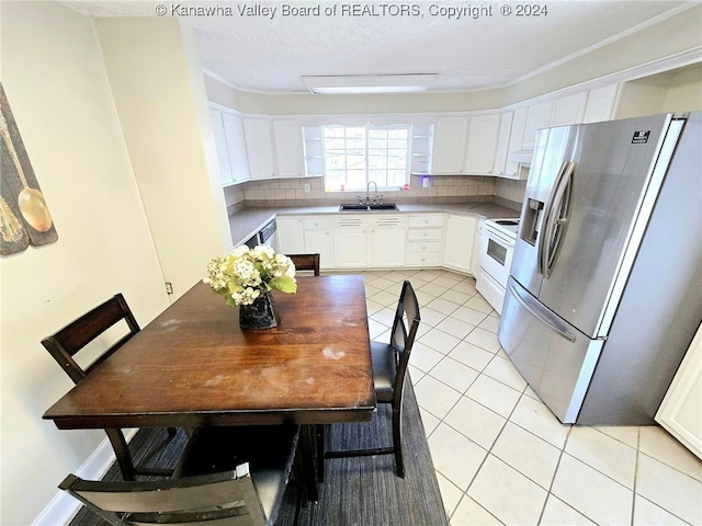 kitchen with white cabinets, tasteful backsplash, stainless steel fridge with ice dispenser, and electric stove