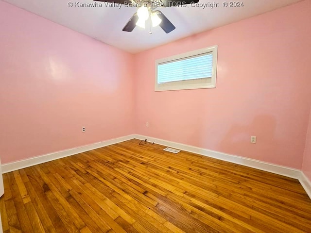 unfurnished room with hardwood / wood-style floors and ceiling fan