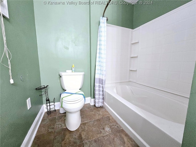 bathroom with toilet and shower / bath combo