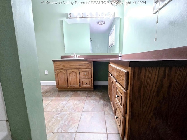 bathroom featuring tile patterned flooring and vanity