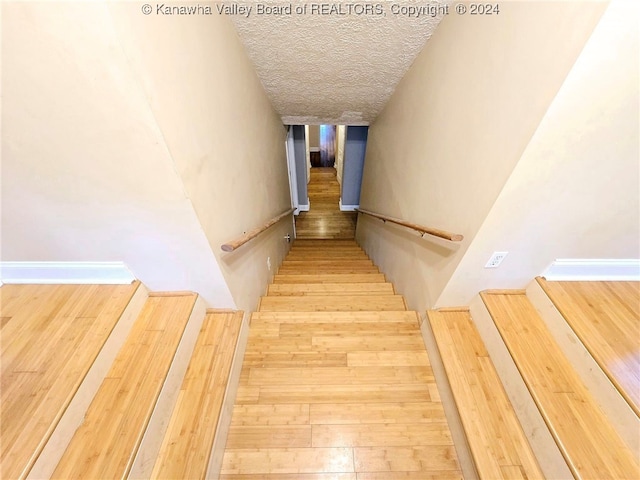 stairs featuring hardwood / wood-style floors