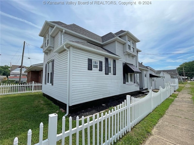 view of side of home with a lawn