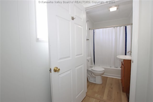 full bathroom with shower / bath combo, wood-type flooring, toilet, and vanity